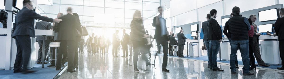 busy entrance with people welcoming guests