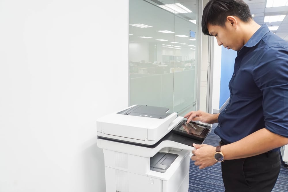 man using hp printer in workplace